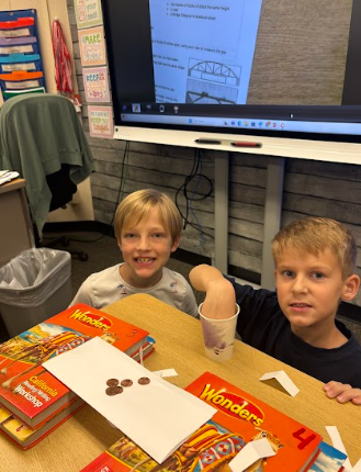 students building bridges out of paper and pennies