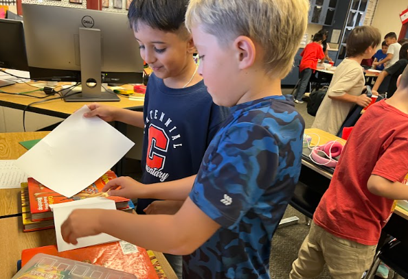 students building bridges out of paper and pennies
