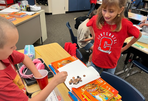 students building bridges out of paper and pennies