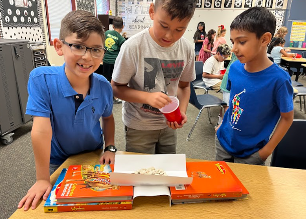 students building bridges out of paper and pennies