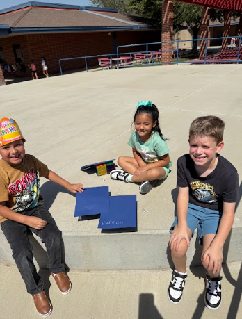 students with structures and paper