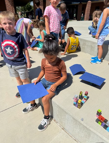 students with structures and paper