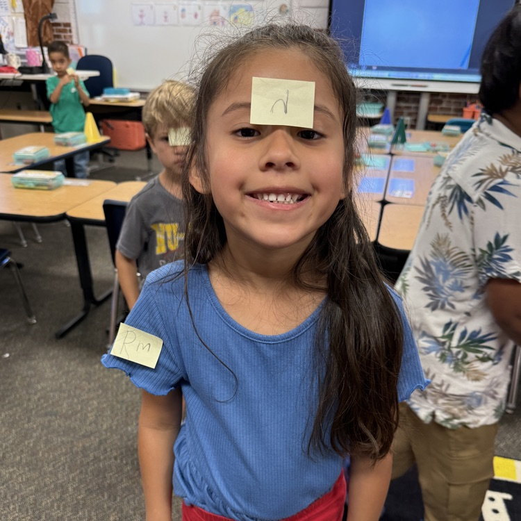 girl with sticky not on her forehead and right arm