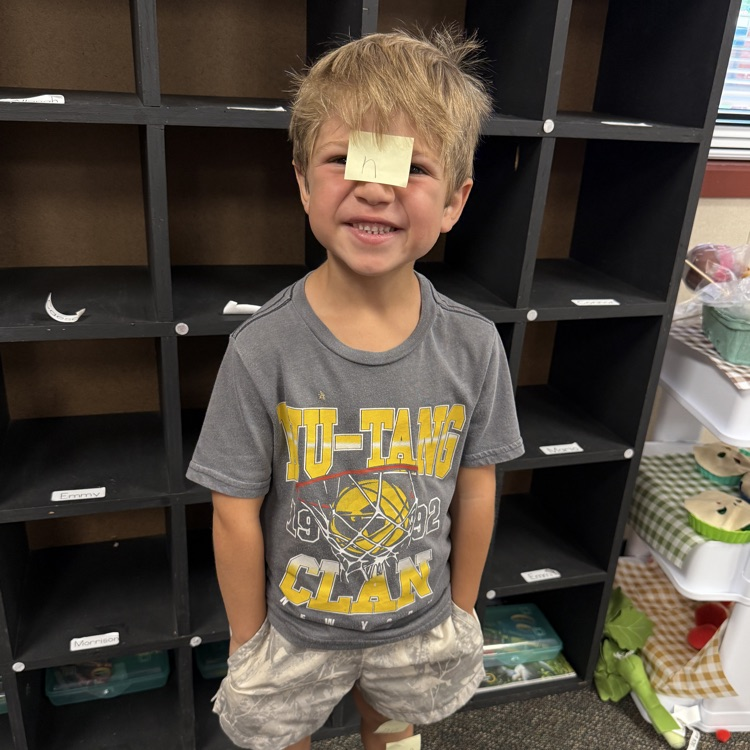 boy with a sticky note on his forehead 