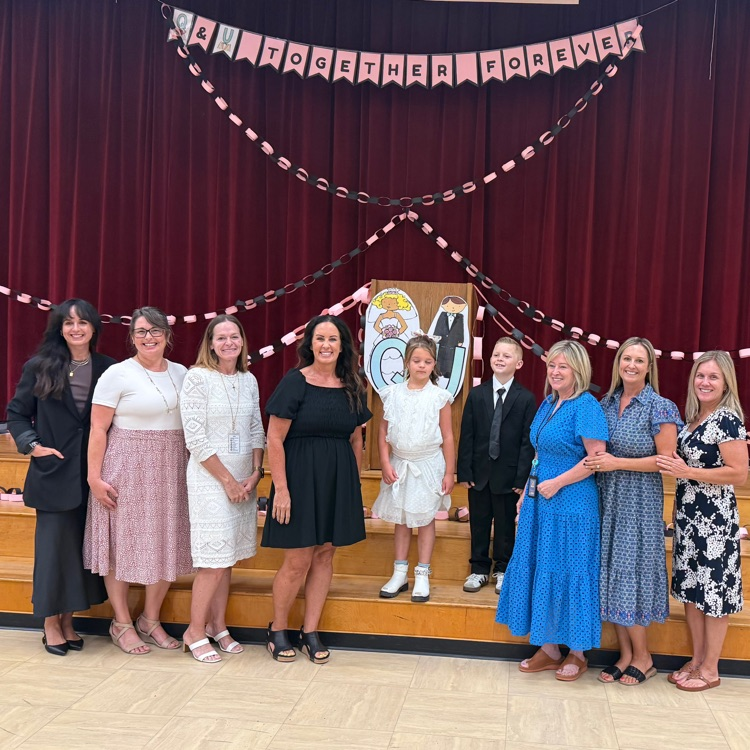 ladies standing with kids dressed as a bride and groom