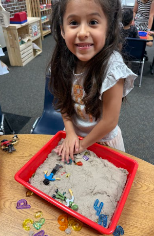student with sand