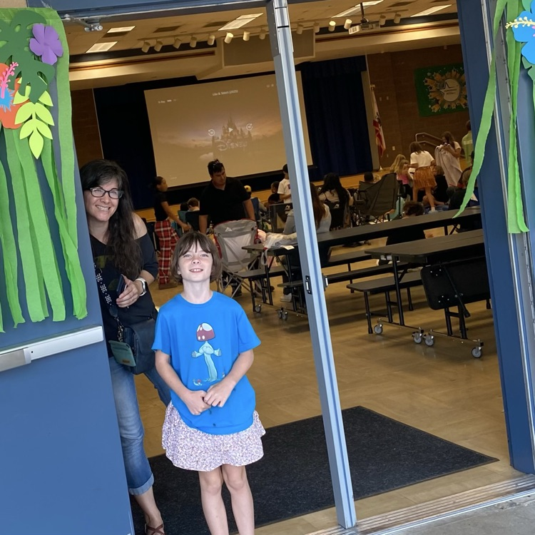 girl standing in doorway smiling