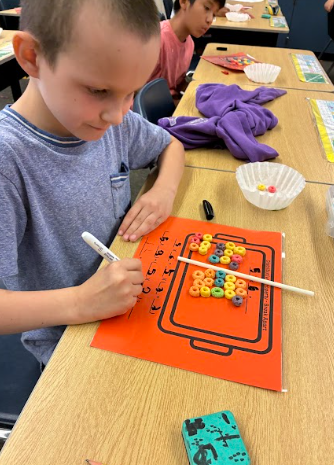student with cereal doing math