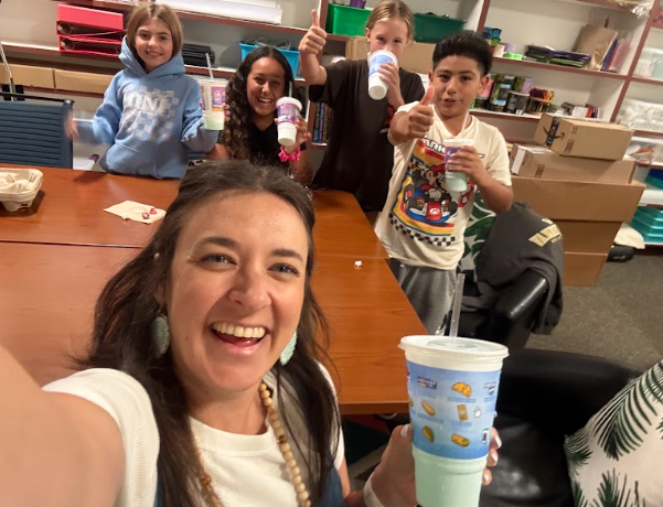 students eating lunch with an adult