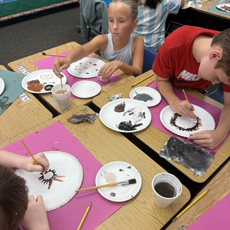 students painting baskets