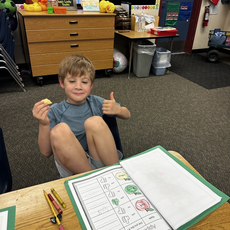 boy giving thumbs up eating an apple 🍎