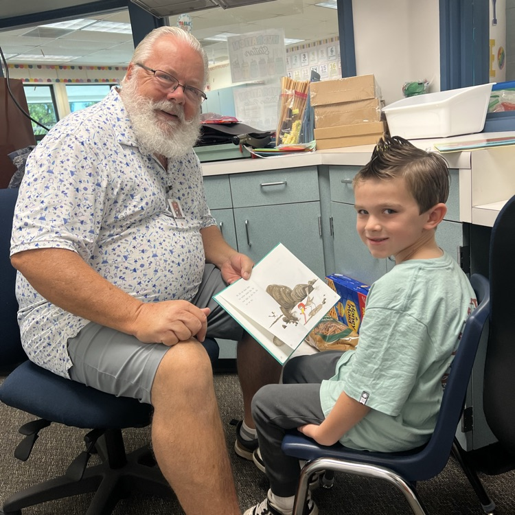 man reading with little boy