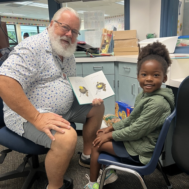 man reading with little girl