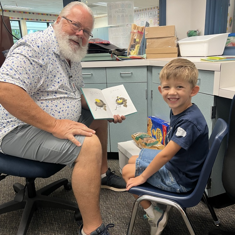 man reading to a boy