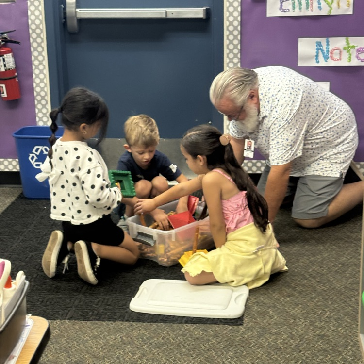 man building with blocks with kids
