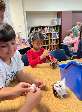 students with pinecones