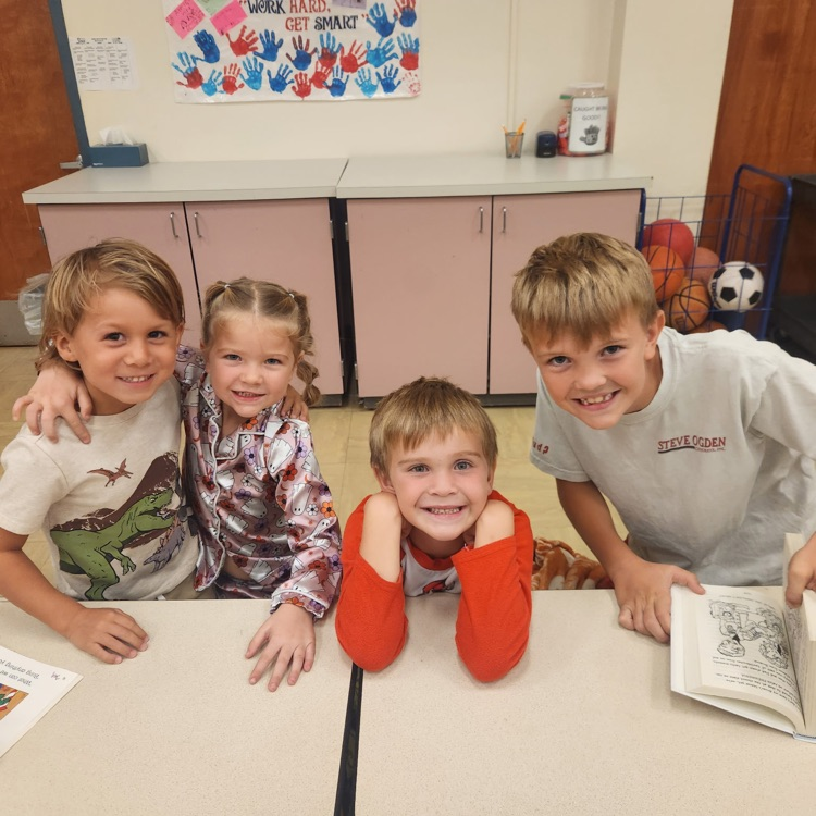 three boys and a girl smiling together