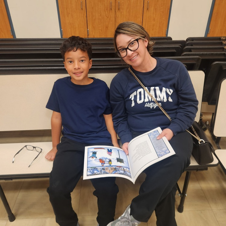 lady and boy looking at a book