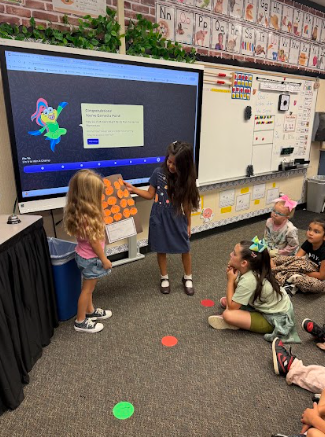 students presenting poster to class