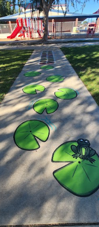 students playing on painted sidewalk