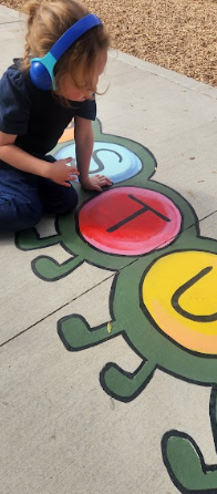 students playing on painted sidewalk