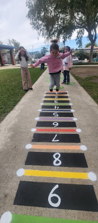 students playing on painted sidewalks