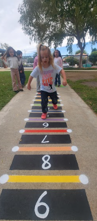 students playing on painted sidewalk