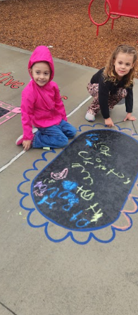 students playing on painted sidewalk