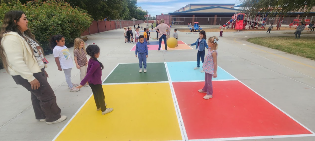students playing on painted sidewalk
