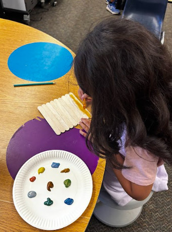 students painting popsicle sticks