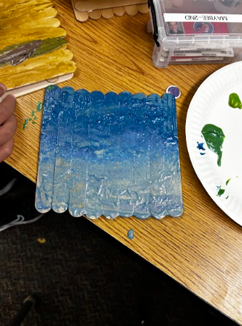 students painting popsicle sticks