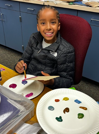 students painting popsicle sticks