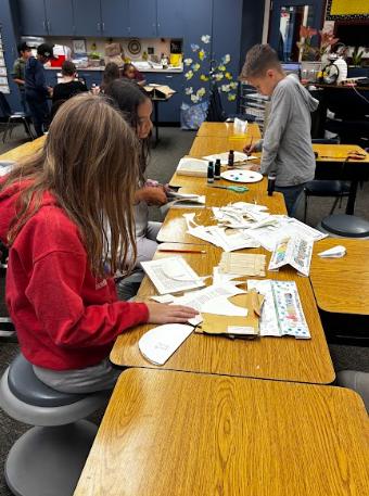 students painting popsicle sticks