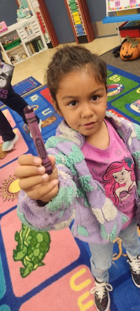 student with purple crayon