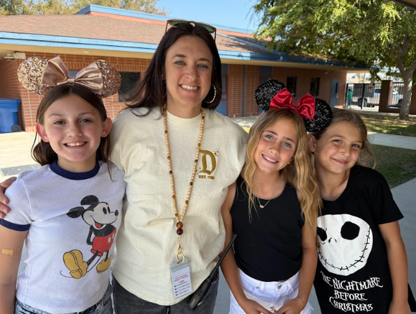 students and teacher in Disney outfits