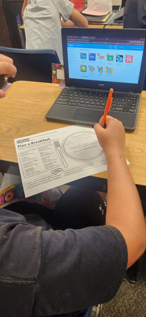 student writing with chromebook