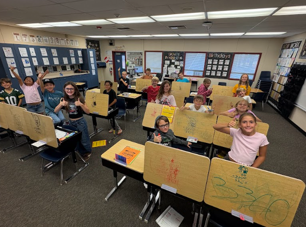 students with desks that are written on