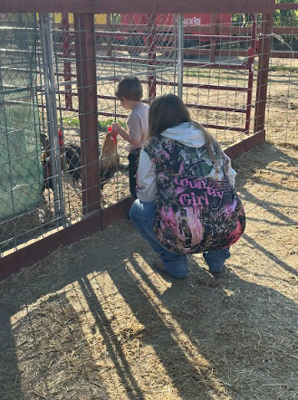 student by a chicken