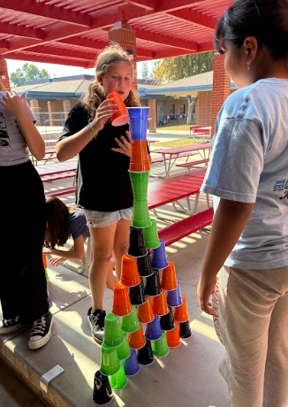 students stacking cups