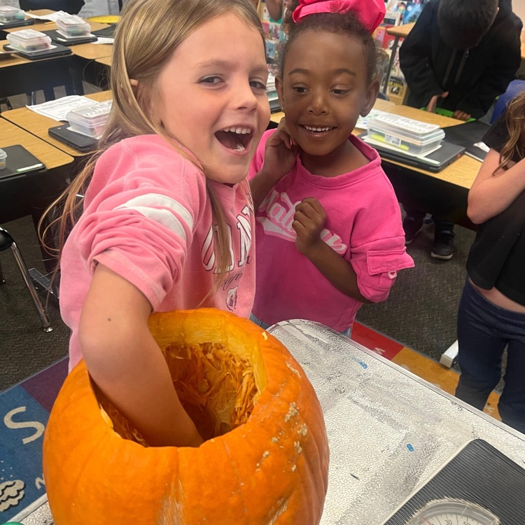 girl cleaning a pumpkin
