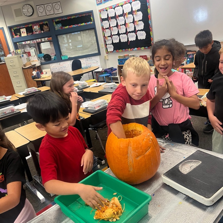 kids cleaning out a pumpkin