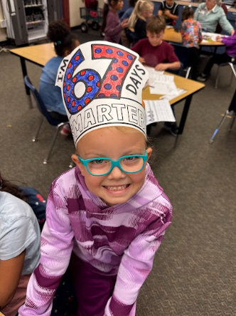 student wearing a 67 hat