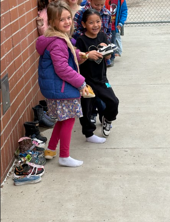 students looking at their shoes with treats