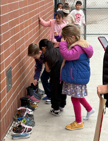 students looking at their shoes with treats