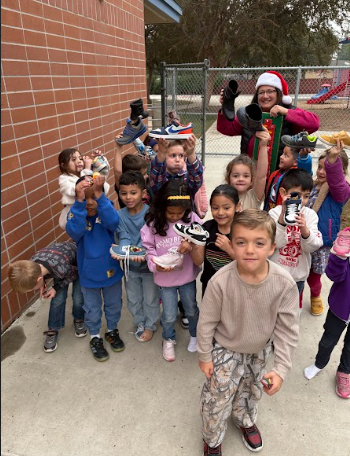 students looking at their shoes with treats