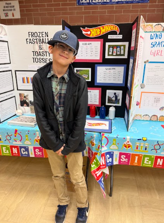 student with a science Fair board