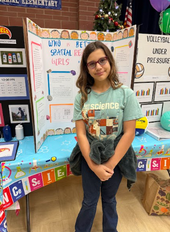 student with a science Fair board