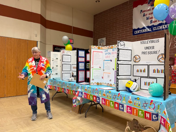 Science Fair judge with boards