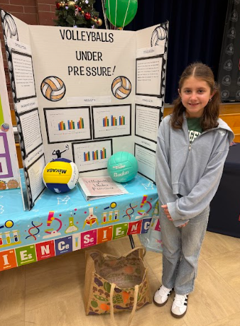 student with a science Fair board