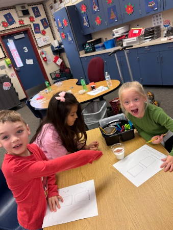 students observing gingerbread cookie floating in a liquid